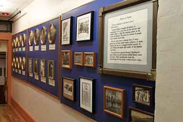 Framed objects hanging on a wall inside a museum.